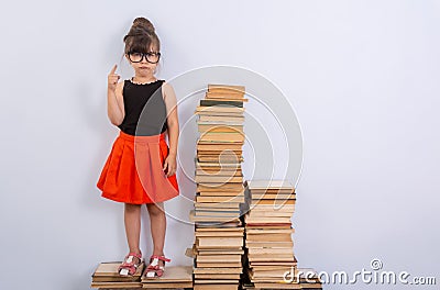 Concept of education and reading. Industrious child. Little Girl reading the book. Stock Photo