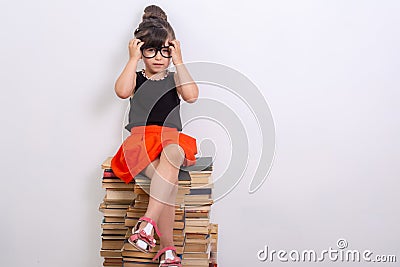 Concept of education and reading. Industrious child. Little Girl reading the book. Stock Photo