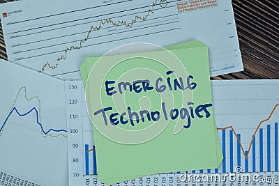 Concept of Emerging Technologies write on sticky notes isolated on Wooden Table Stock Photo