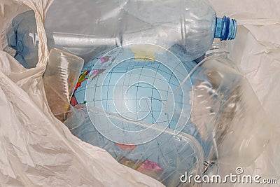 The concept of environmental pollution by plastic waste. Globe is in a bag with plastic trash. A model of the planet Earth was thr Stock Photo