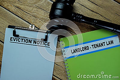 Concept of Eviction Notice write on paperwork and Landlord - Tenant Law on a book isolated on Wooden Table Stock Photo