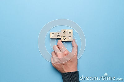 Concept of fact and fakes on wooden cubes Stock Photo