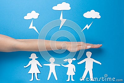 Concept of family safety. Life insurance and family health. Paper origami people hold hands Stock Photo