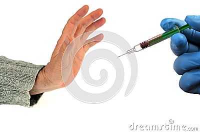 Concept of refusal of vaccination with a hand opposing a syringe close-up on a white background Stock Photo