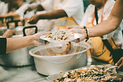 The concept of feeding : The hands of the poor receive food from the hands of the humane : Helping Feed the Poor Stock Photo