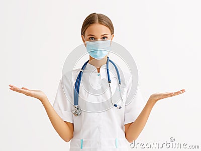 Concept of fighting and prevention coronavirus infection covid 19. woman doctor in protective medical mask spreads arms out to Stock Photo