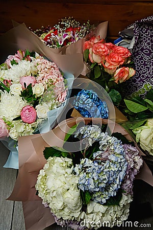 the concept of a flower shop. Close-up of several beautiful lovely bouquet of mixed flowers. Wallpaper Stock Photo