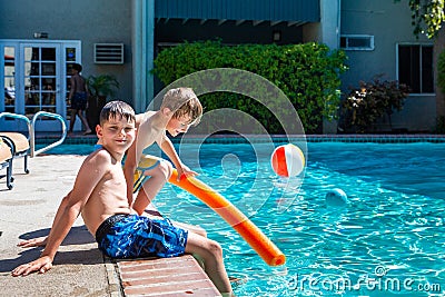 Oudoor summer activity. Concept of fun, health and vacation. Brothers boys eight and five years old with noodle sits Stock Photo