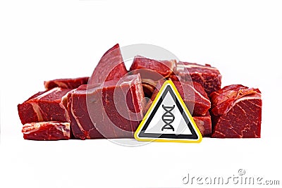 Concept for genetically modified meat for human consumption, showing chunks of red meat with yellow DNA gene warning sign Stock Photo