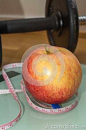 Concept - Getting in Shape, Measuring Tape, Apple, Scale and Dumbbell Stock Photo