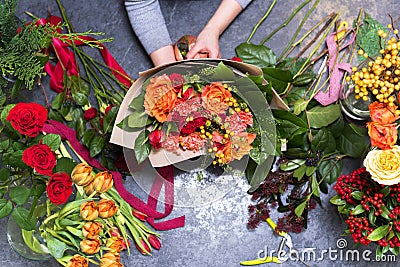 The concept of gifts and bouquets for March 8 and Mother`s Day. Florist creates a bouquet in a flower shop Stock Photo