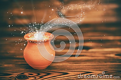 Concept greeting card of clay pot with mystical miracle light on Stock Photo