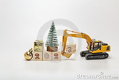 Concept Happy new year 2023,Crawler excavator with bucket lift up that is installing the numbers three. Stock Photo