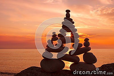 Concept of harmony and balance. Rock Zen at sunset. Stock Photo