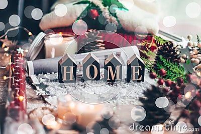 Concept of Home and comfort. Christmas decor Warm sweater, candles, Christmas tree. Word Home. Winter mood, Cozy Home Stock Photo