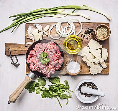 Concept of home cooking minced meat with vegetables, spices and herbs on wooden rustic background top view close up Stock Photo