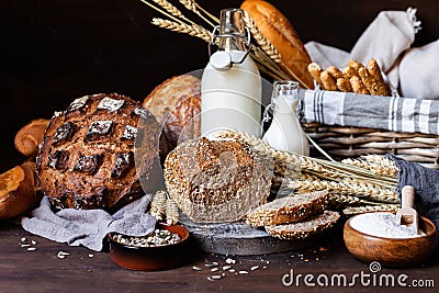 Concept of homemade bread, natural farm products, domestic production. Healthy and tasty organic food. Cut bread, milk, flour. Stock Photo