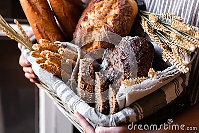 Concept of homemade bread, small bakery, natural farm products, domestic production. Healthy and tasty organic food. Woman holding Stock Photo