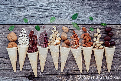 Concept for homemade various nuts ice cream. Mixed nuts in waffles. Stock Photo