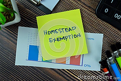 Concept of Homestead Exemption write on sticky notes isolated on Wooden Table Stock Photo