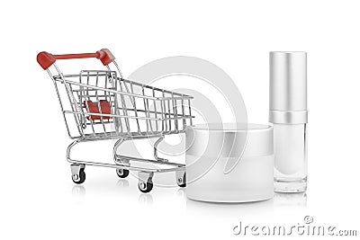 Concept idea shopping, mock up a empty container cream jar and a bottle of cosmetic cream and a small shopping cart. Stock Photo