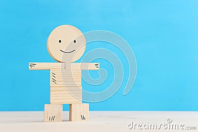 Concept image of happy mind and positive thinking. Wooden figure with smiling face Stock Photo