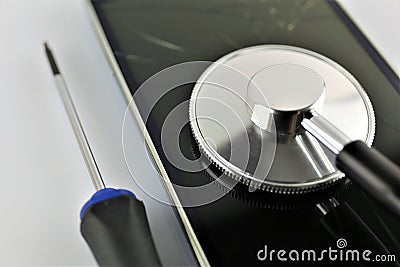 An concept image of a smart phone diagnostic with gadgets and a stethoscope Stock Photo