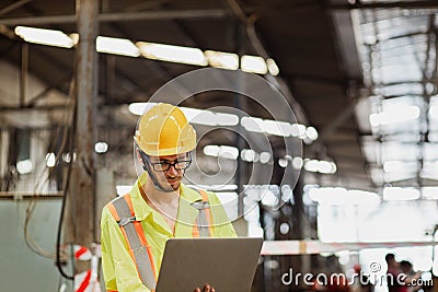 Engineer looking of process performing mechanical turning operation at machine setup in factory Stock Photo