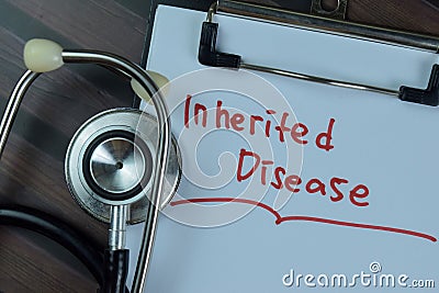 Concept of Inherited Disease write on a paperwork with stethoscope isolated on Wooden Table Stock Photo