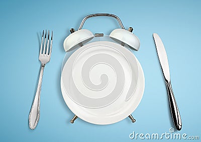 Concept of intermittent fasting, diet and weight loss. Plate as Alarm clock Stock Photo