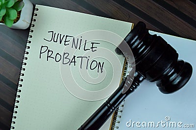 Concept of Juvenile Probation write on a book with gavel isolated on Wooden Table Stock Photo