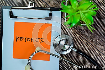 Concept of Ketones write on sticky notes with stethoscope isolated on Wooden Table Stock Photo