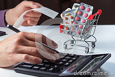 Concept of large spending on medicines. Shopping cart full of medicines and pills Stock Photo