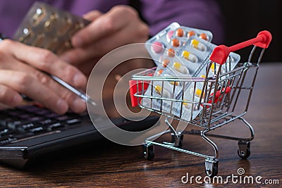 Concept of large spending on medicines. Shopping cart full of medicines and pills Stock Photo