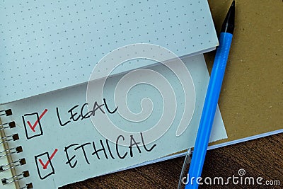 Concept of Legal and Ethical write on book isolated on Wooden Table Stock Photo