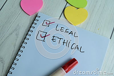 Concept of Legal and ethical write on book isolated on Wooden Table Stock Photo