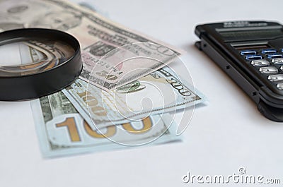 The concept of lending. Money, calculator, magnifier. Stock Photo