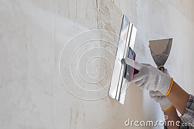 The concept of leveling and plastering a surface using a spatula Stock Photo