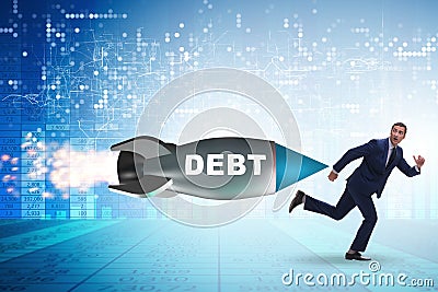 Concept of loan and debt with businessman chased by rocket Stock Photo