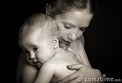 Concept for love and family. mother hugging baby tenderly in mon Stock Photo