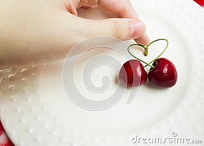 The concept of love - heart from berries of a sweet cherry.Isolated cherry. Heart shape from two cherries isolated white Stock Photo