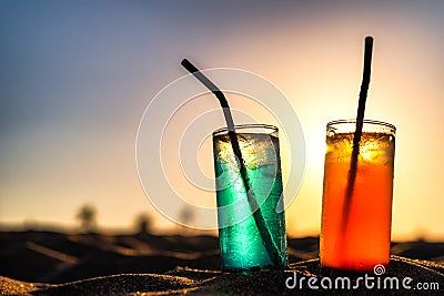 Concept of luxury tropical vacation. Classic cocktails in sand Stock Photo