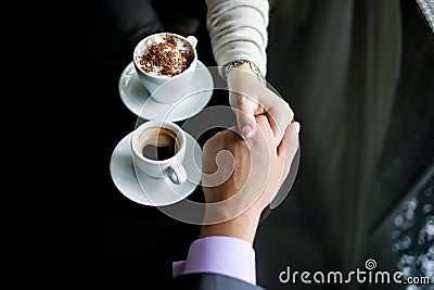 Concept of male and female hands, love and coffee Stock Photo