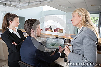 concept manager questioning receptionist Stock Photo