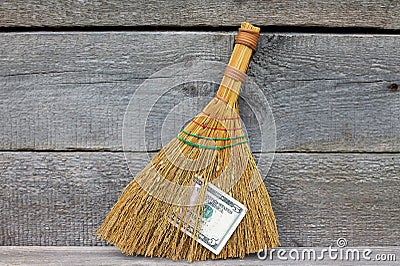 Concept of mismanagement. Broom stuck with dollars Stock Photo