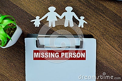 Concept of Missing Person write on paperwork on a book isolated on Wooden Table Stock Photo