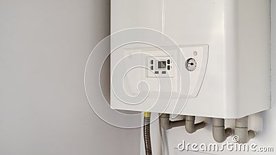 White modern gas water heater at the kitchen closet Stock Photo