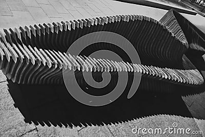 The concept modern wave pattern of a wooden slatted Bench on the coast. Stock Photo