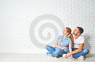 Concept of mortgage housing problems. couple at blank wall Stock Photo