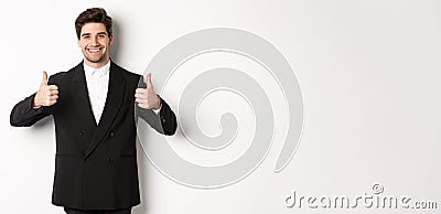 Concept of new year party, celebration and lifestyle. Image of attractive happy businessman in formal suit, showing Stock Photo